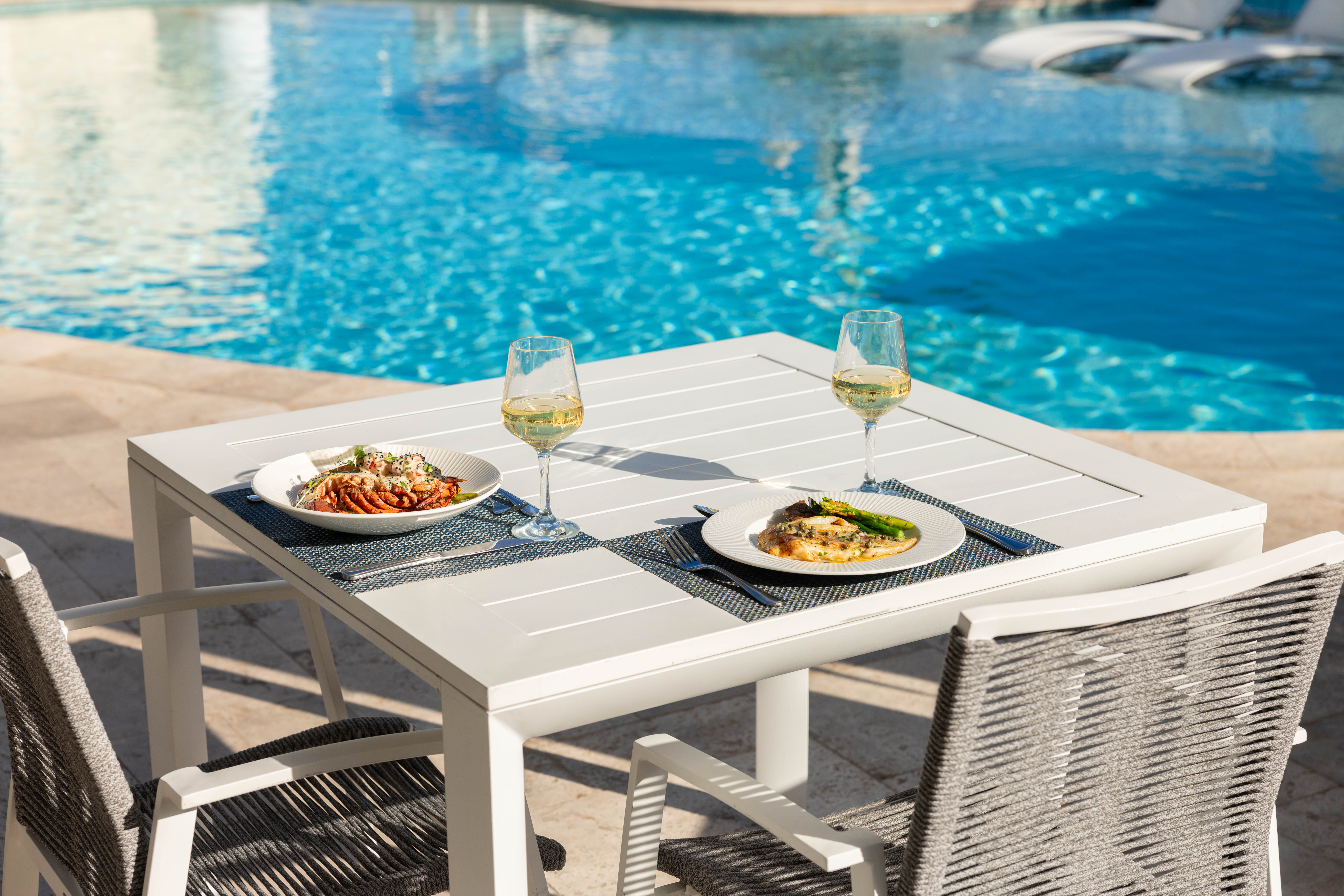 dining table by pool.