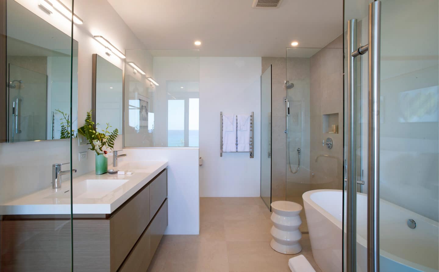 A bathroom with two sinks, a shower, and a bathtub.