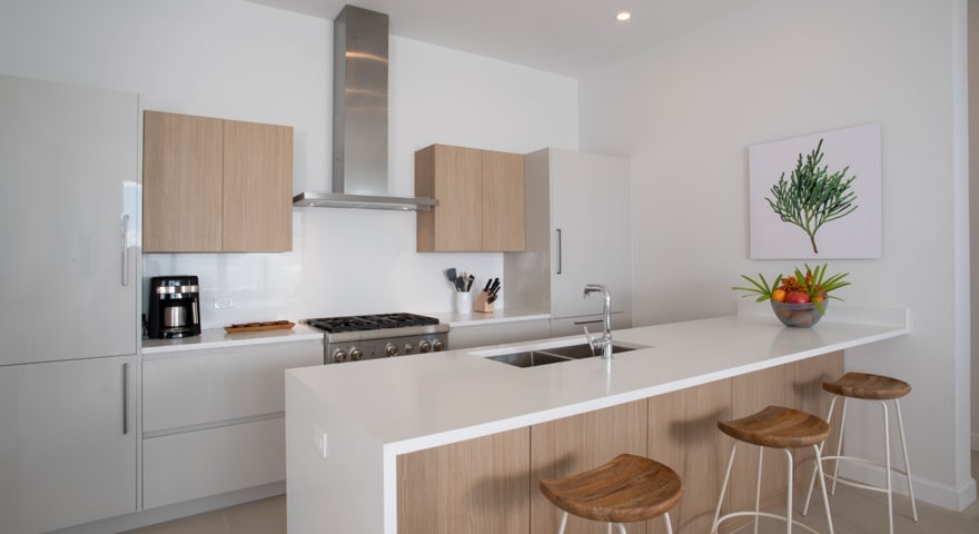 A kitchen area with white walls and wooden accents.