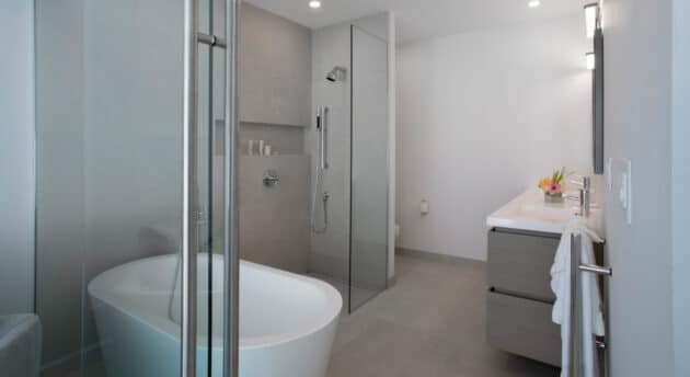 A bathroom with a tub, a shower booth, and a sink.