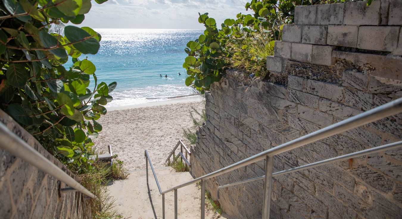 A small staircase leading to a beach.