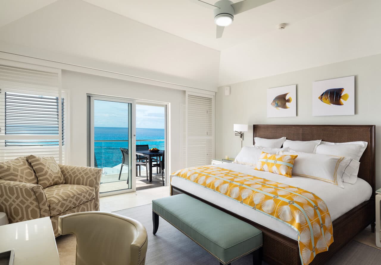 A bedroom with glass sliding doors leading to an outdoor deck.